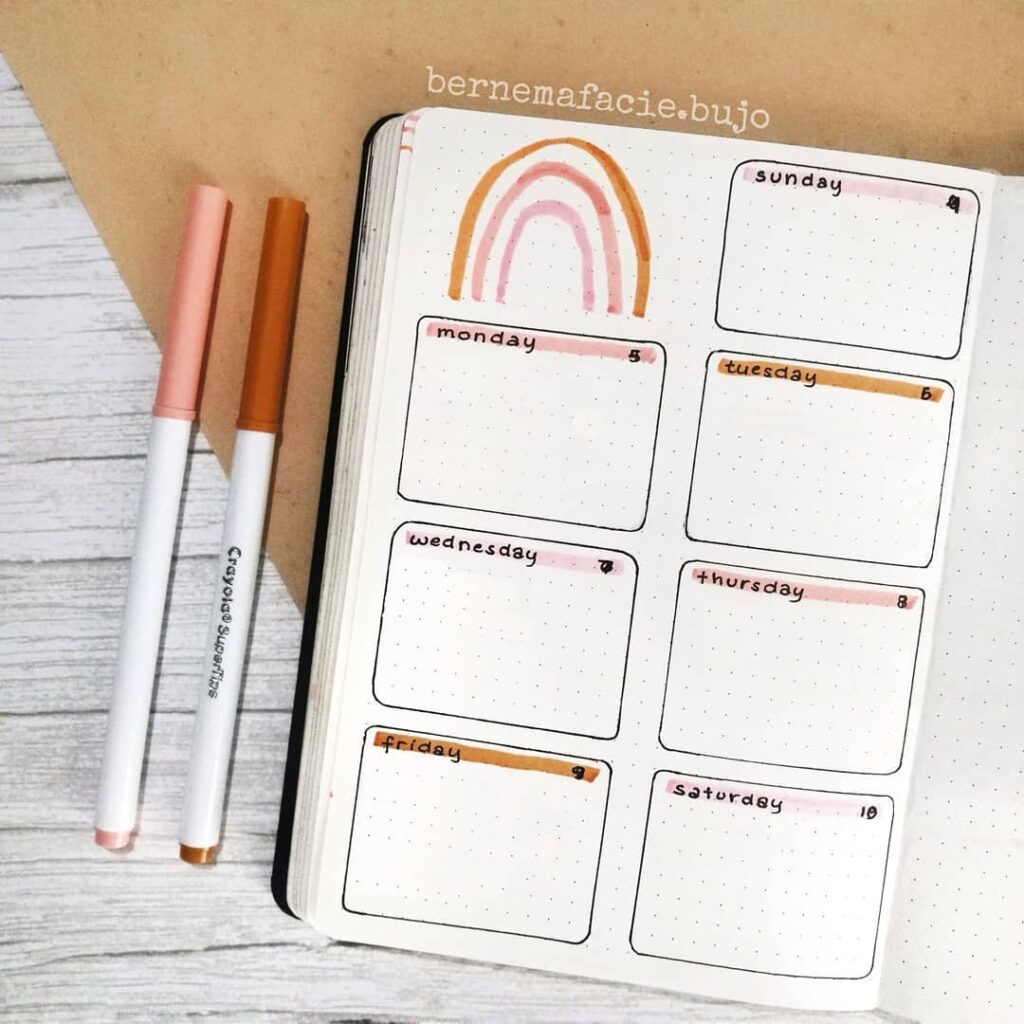 Bullet journal weekly layout with pastel rainbow and pens; organized planning for productivity.