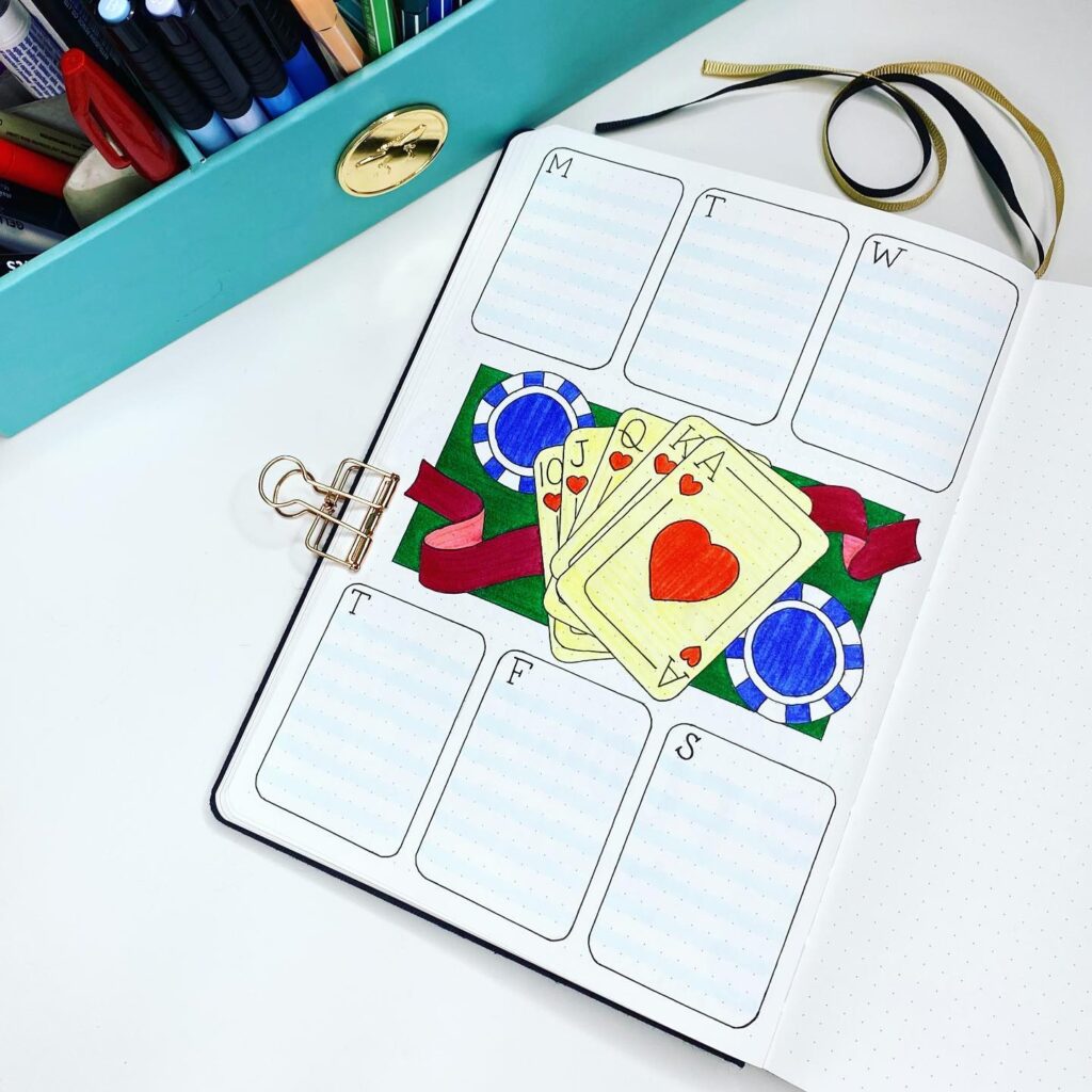 Weekly planner with poker card design, chips, and vibrant colors on a desk with stationery.