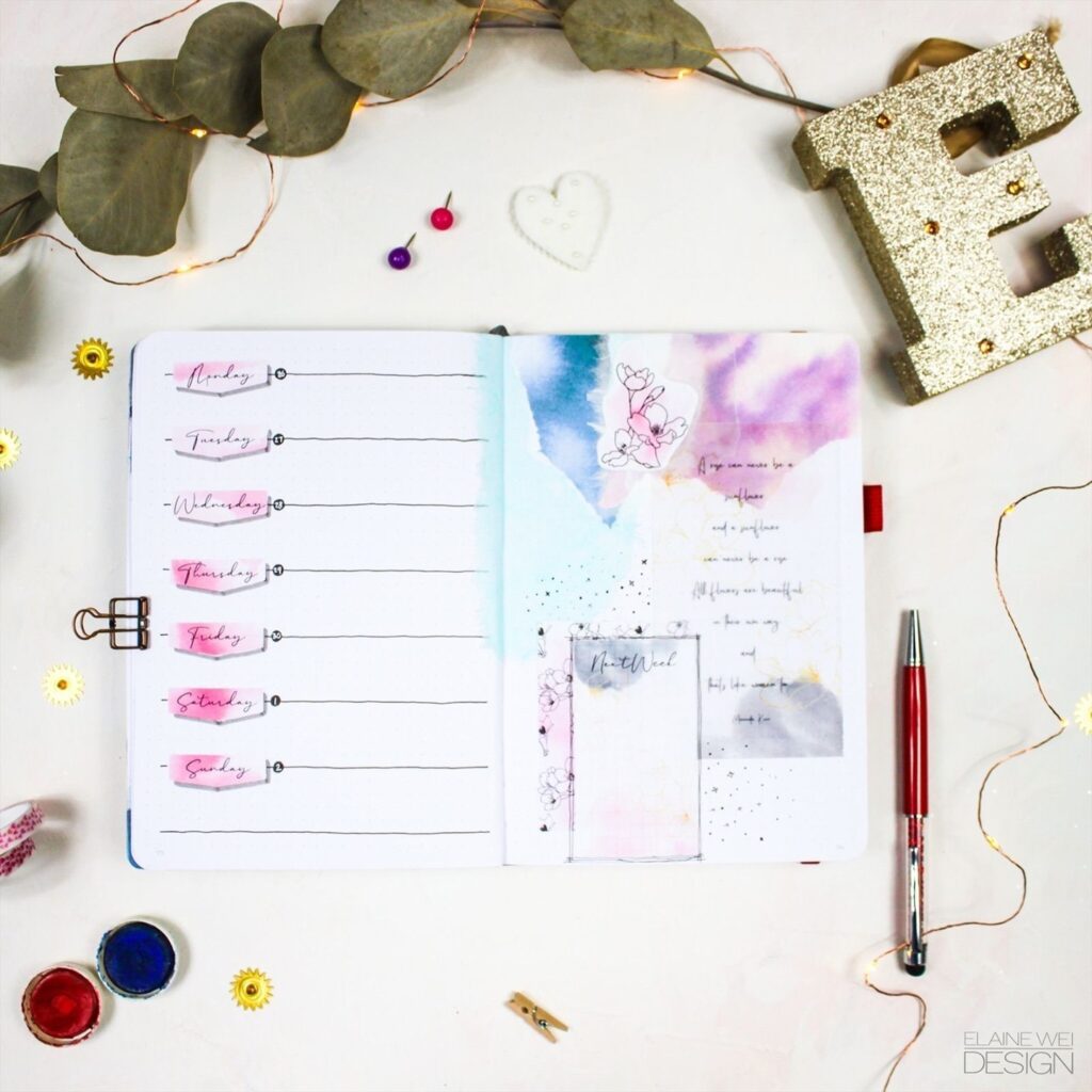 Open planner with pastel designs and weekly schedule, surrounded by decorative items and a glittery letter E.