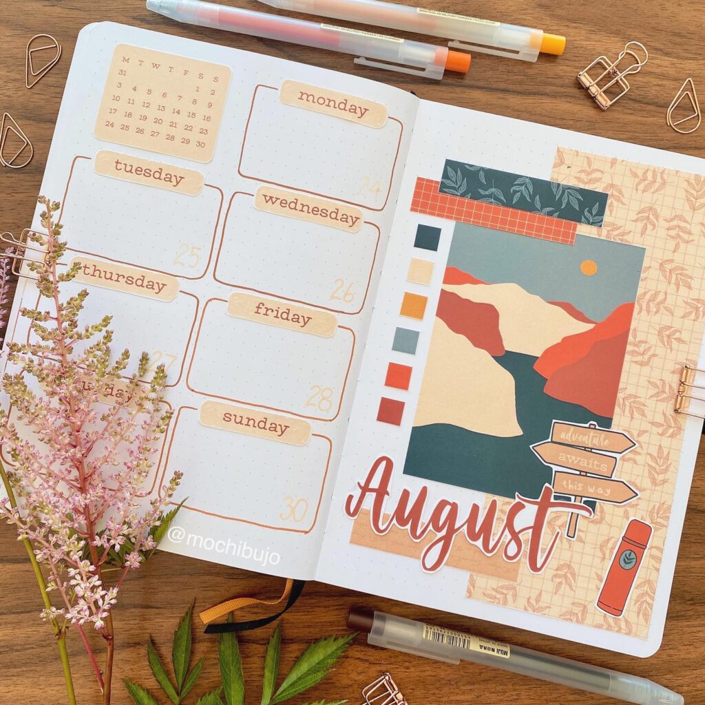 August bullet journal spread with mountain landscape art, weekly planner, and decorative elements.