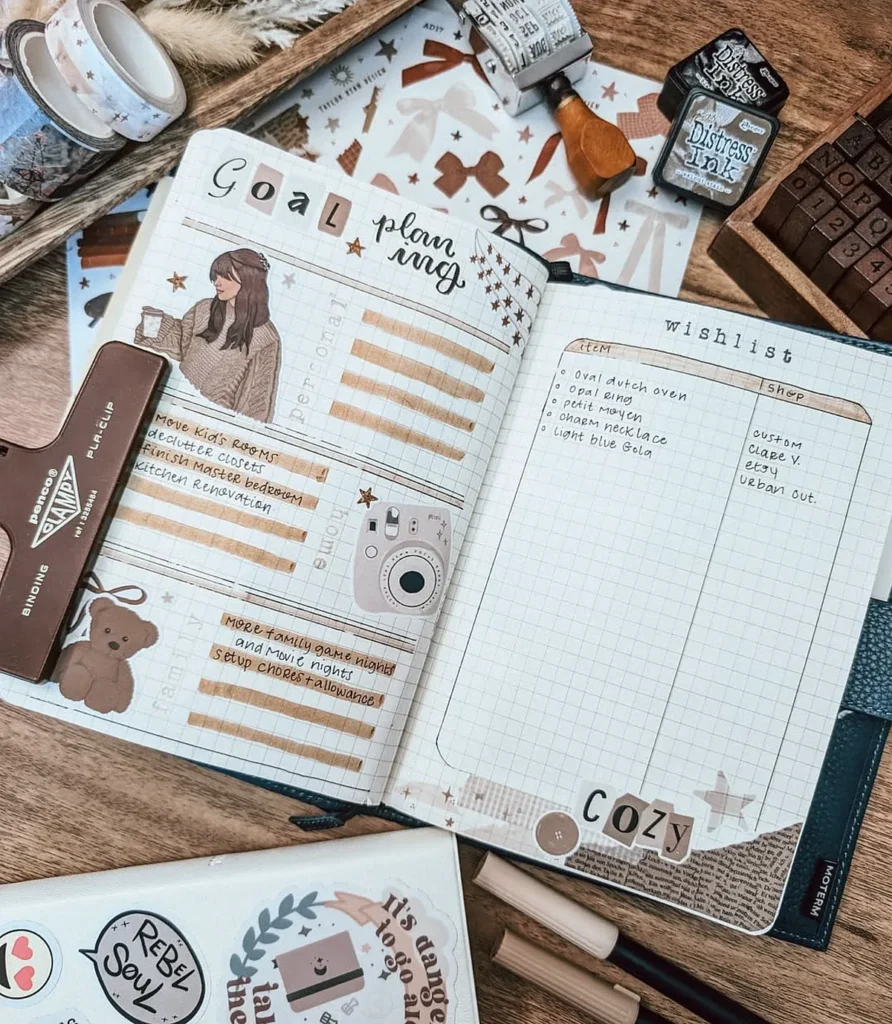 Open planner with goal planning and wishlist, surrounded by crafting supplies on a wooden table. Cozy aesthetic.