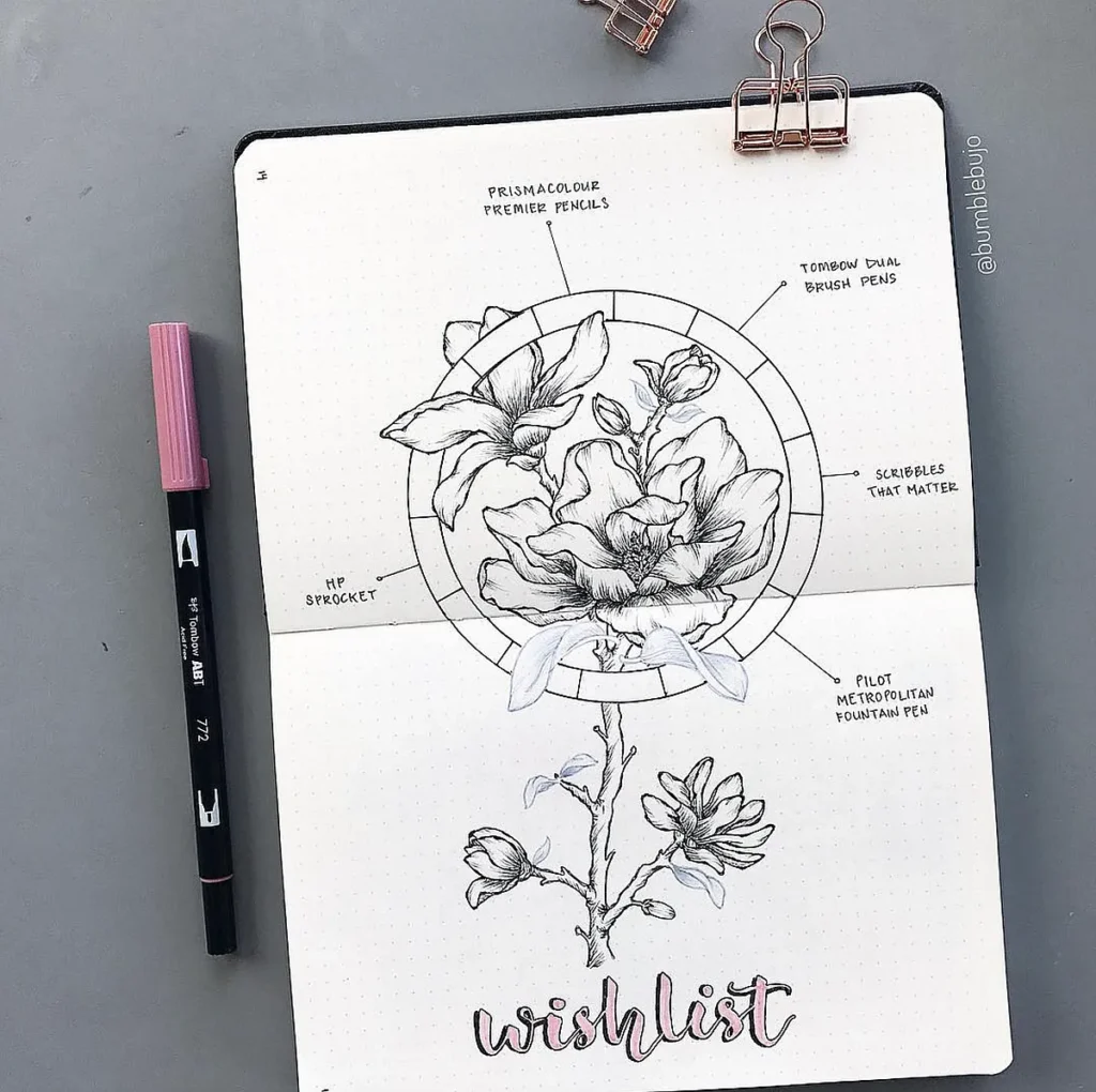 Bullet journal wishlist page with flower drawing and stationery items like pens and pencils, styled with a binder clip.
