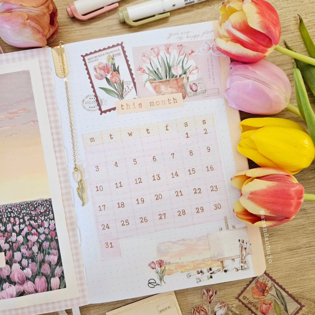Decorative planner with tulip illustrations, monthly calendar spread, and colorful tulips in the corner.