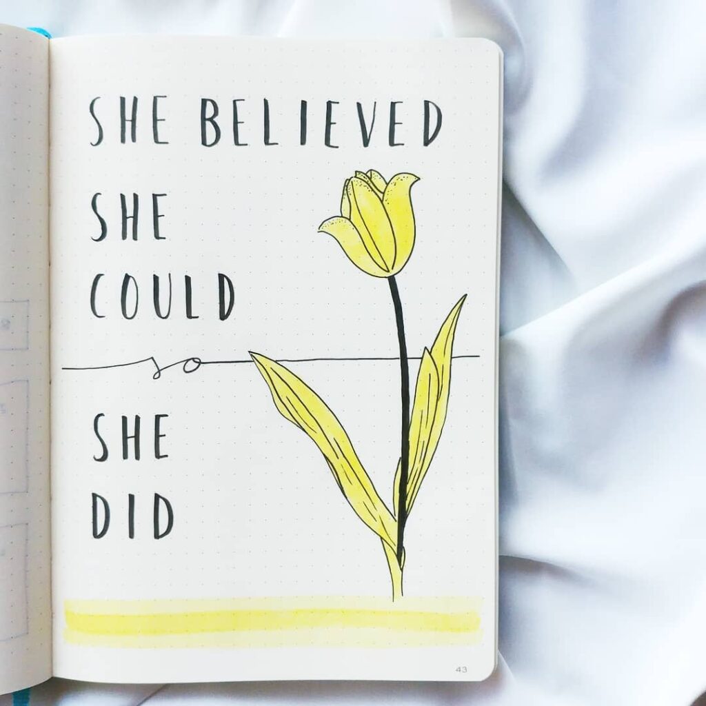 Inspirational quote She believed she could so she did with a hand-drawn yellow flower in a journal.