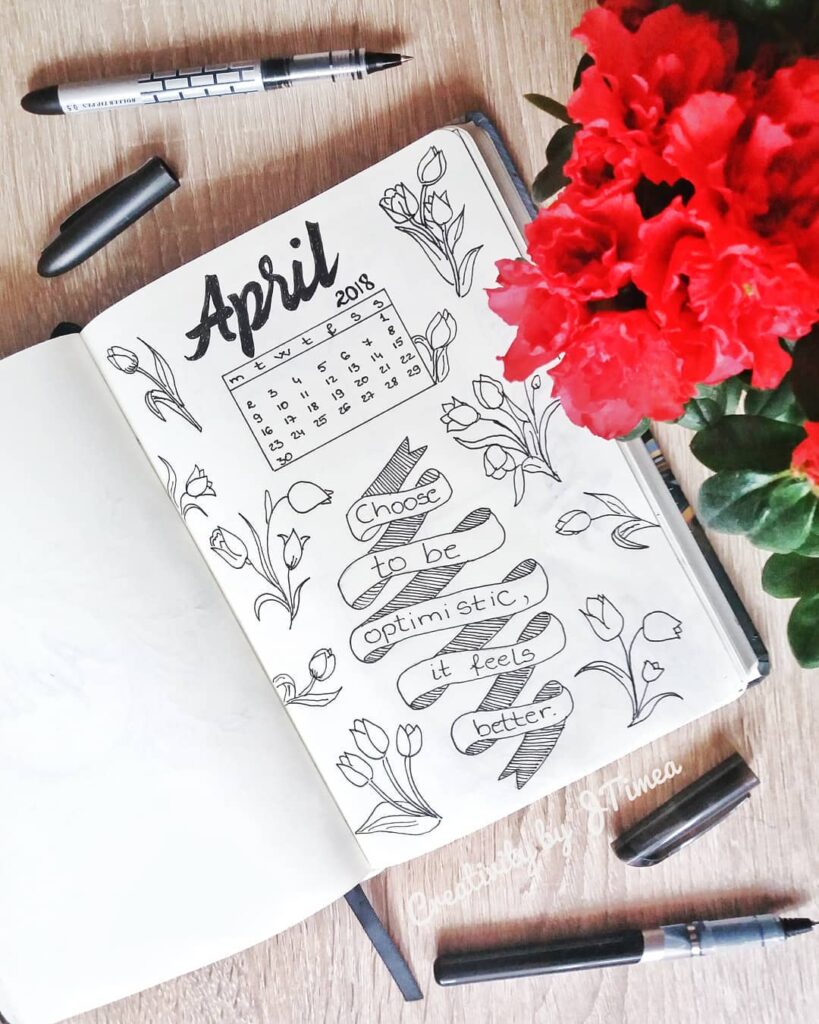 April 2018 bullet journal layout with floral doodles and motivational quote Choose to be optimistic, it feels better.