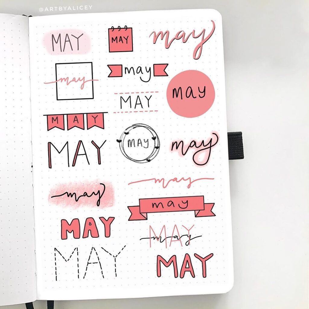 Creative 'May' lettering styles in pink on a dotted notebook page, perfect for planners and bullet journals.