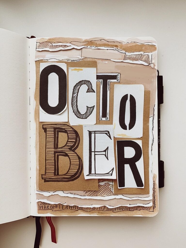 Artistic October bullet journal spread with layered paper and bold lettering design.