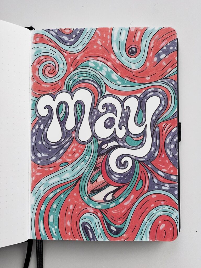 Colorful journal page with May in bold letters and swirled red, teal, and purple patterns.