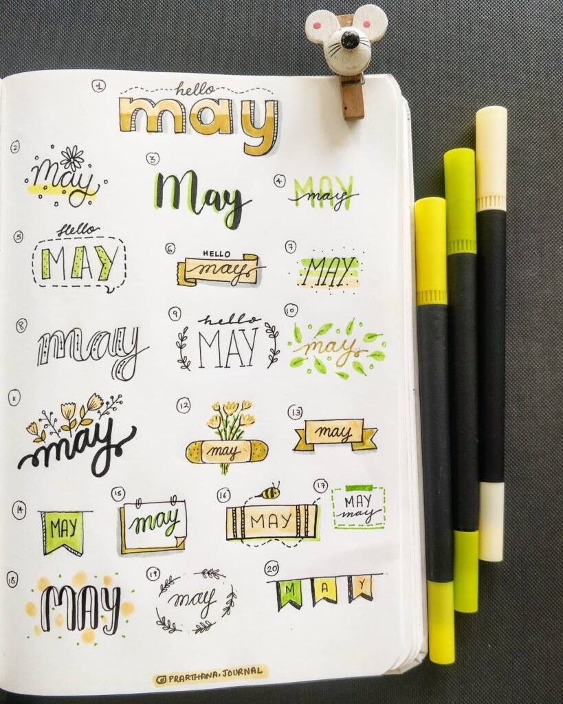 Creative bullet journal header ideas for May with pens and a cute mouse clip.