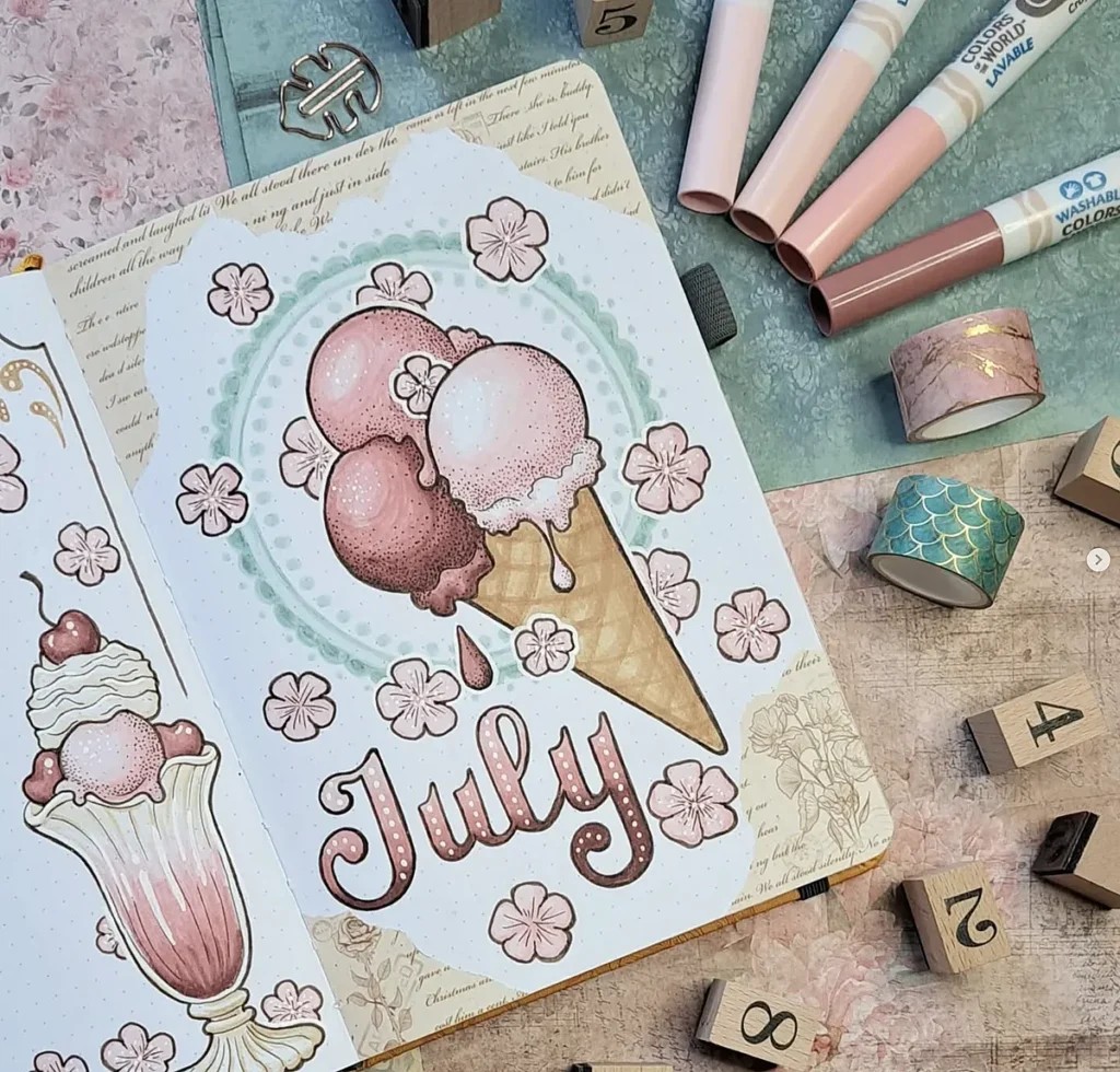 July-themed journal page with ice cream cone illustration, surrounded by flowers and decorative stationery items.