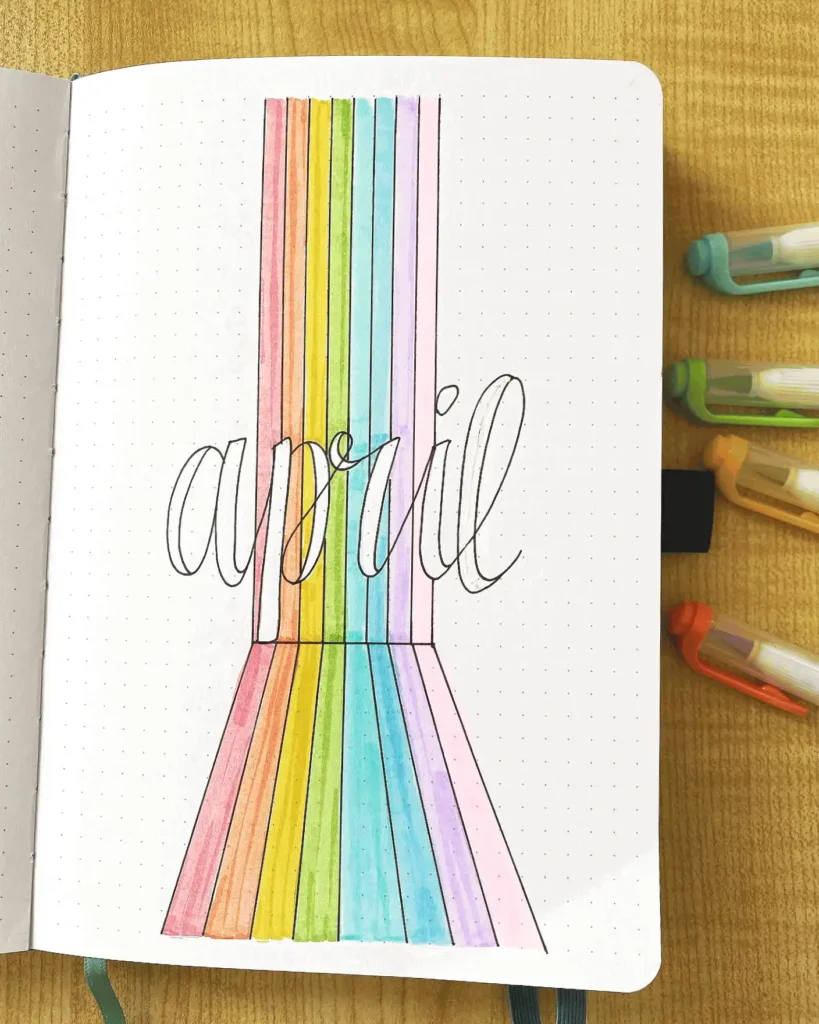 Colorful April journal page with rainbow lines, bullet journal theme, creative design.