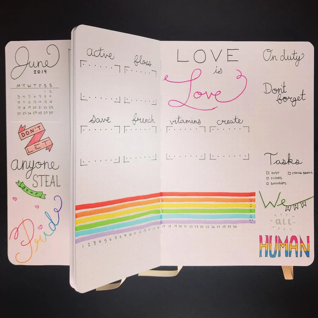 Colorful June bullet journal spread featuring goals, tasks, and rainbow pride theme.