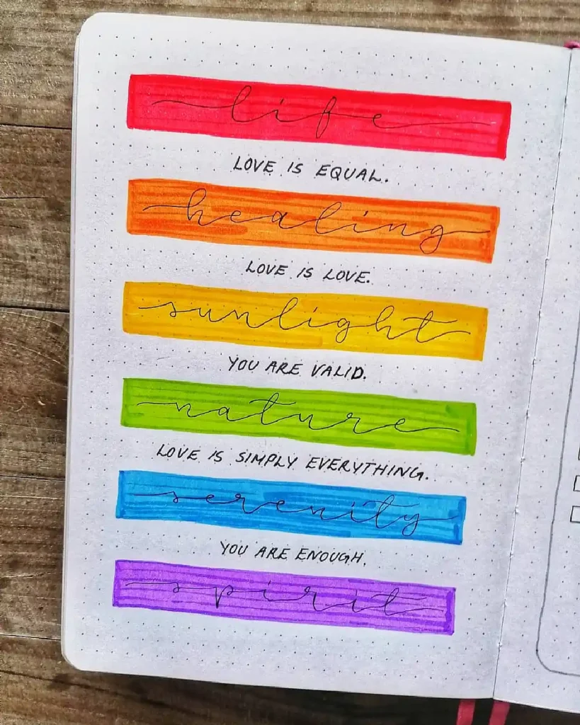 Colorful hand-lettered affirmations in a journal emphasizing love, healing, and self-worth.
