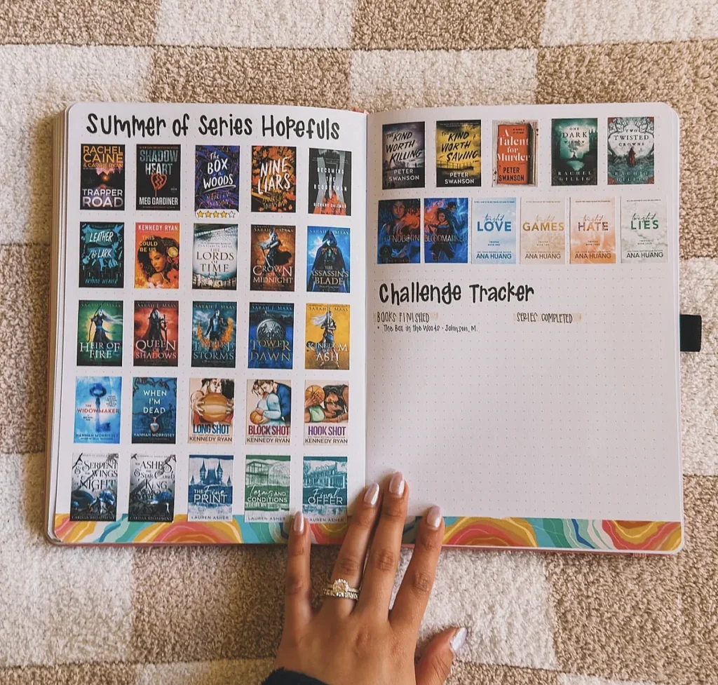 Bullet journal page with a book series list and a reading challenge tracker. Hand resting on the left page.
