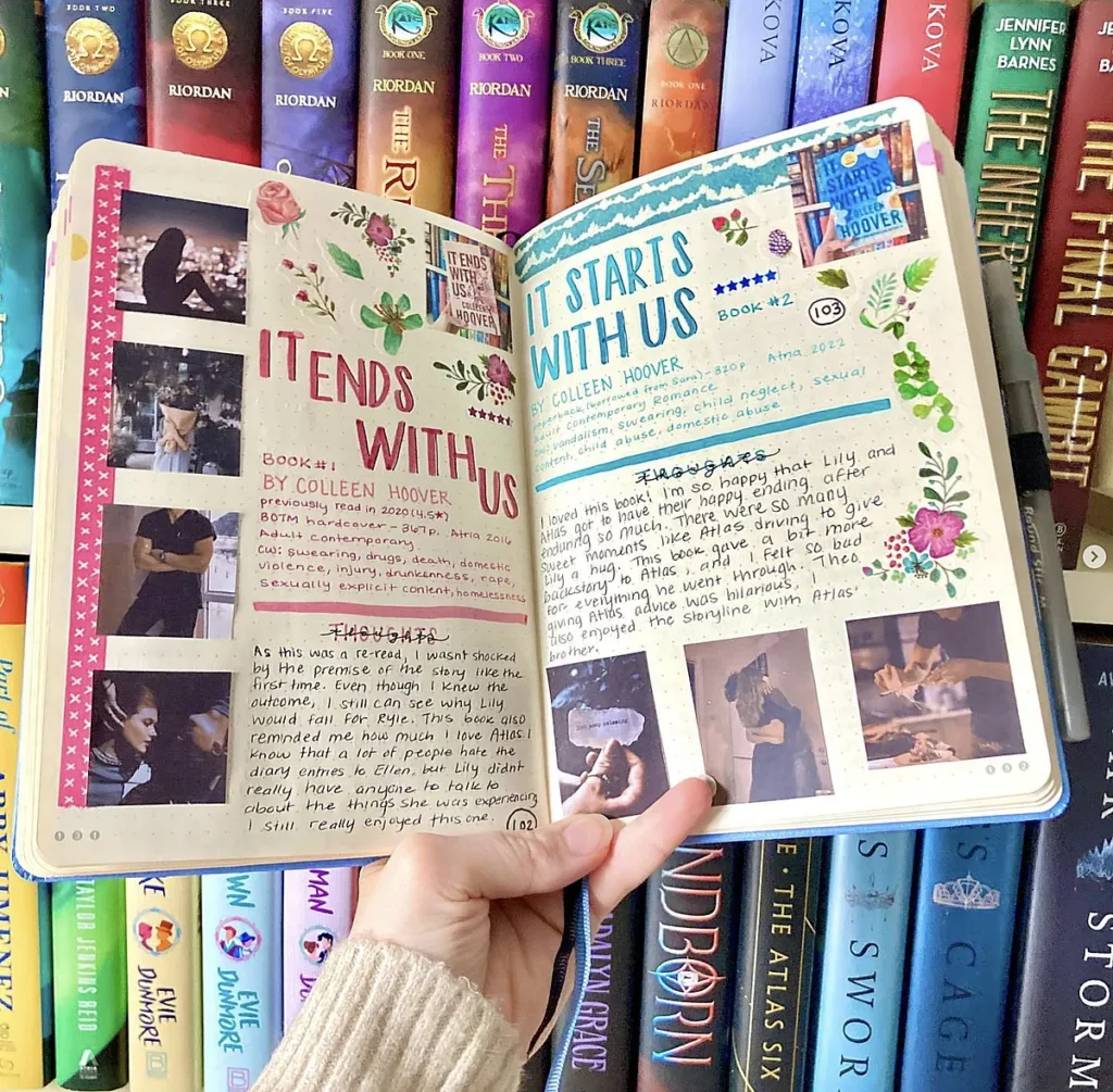 Hand holding a journal with decorated pages featuring It Ends With Us and It Starts With Us by Colleen Hoover.