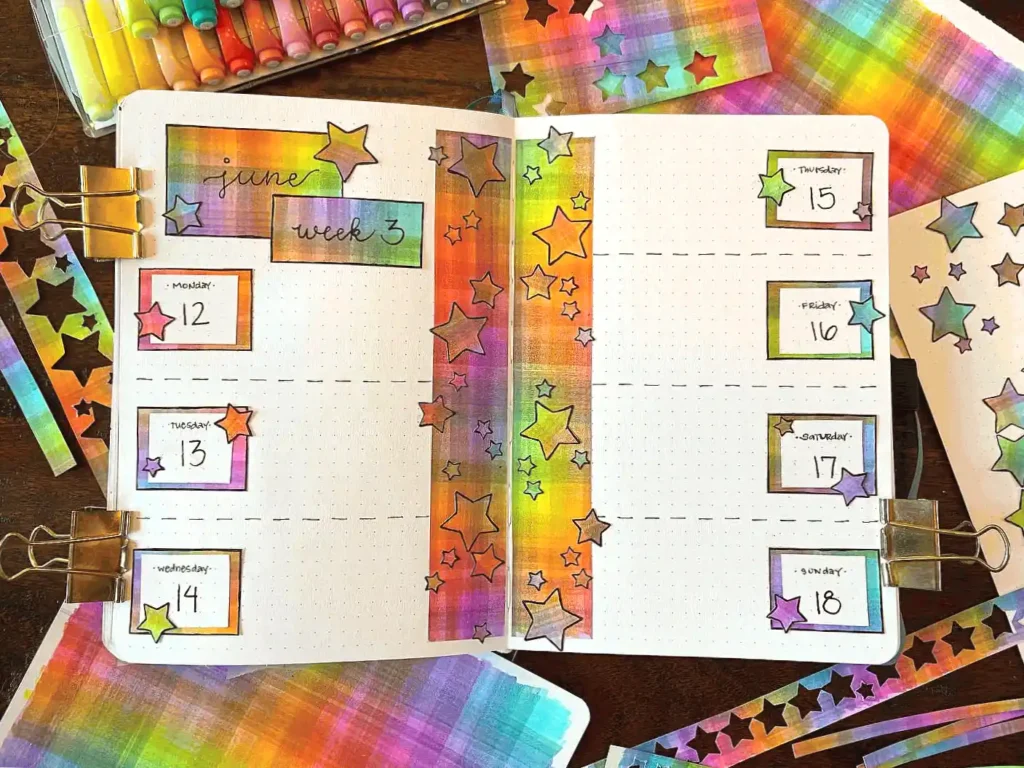 Colorful bullet journal weekly spread for June with star decorations and vibrant design elements.