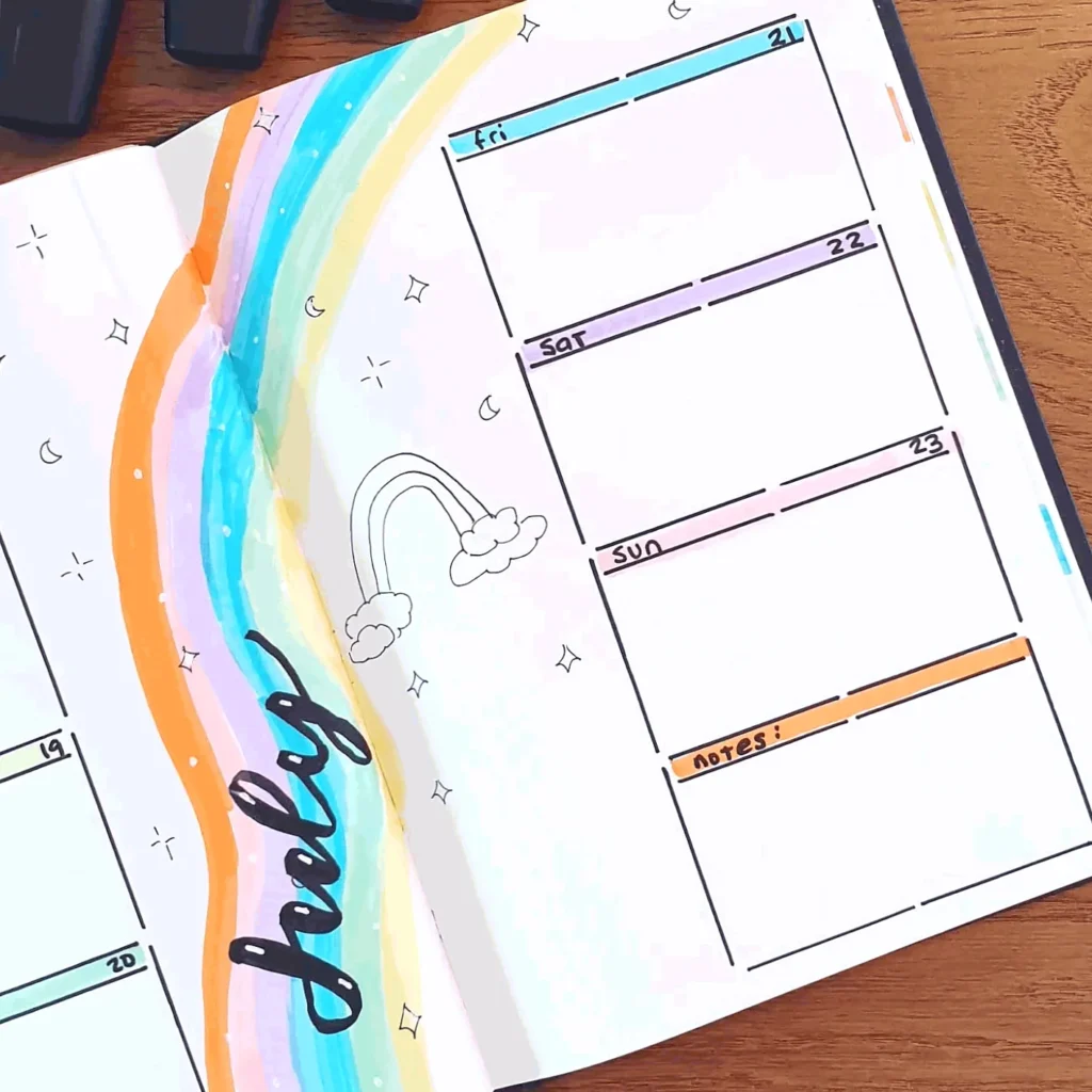 Colorful weekly planner with rainbow design open on a wooden desk, featuring days of the week and notes section.