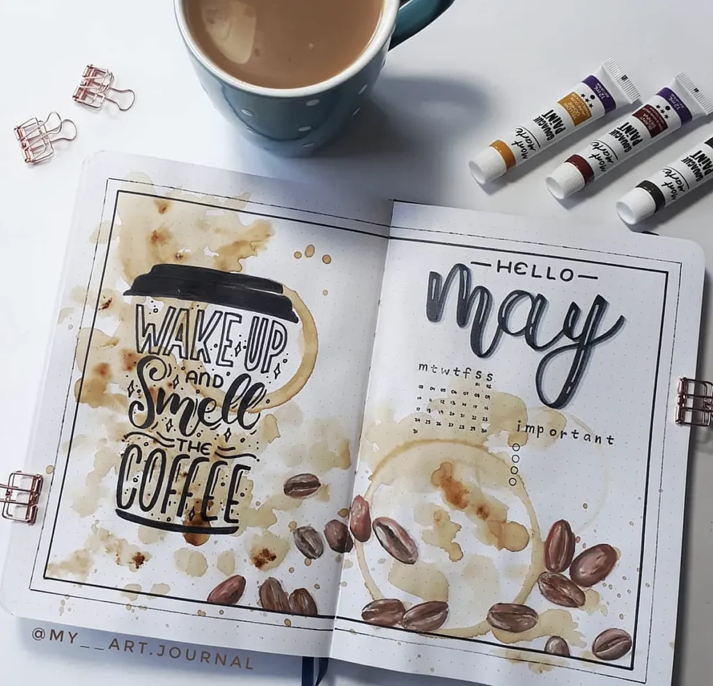 Bullet journal with coffee theme, featuring Wake Up and Smell the Coffee lettering and May calendar design.