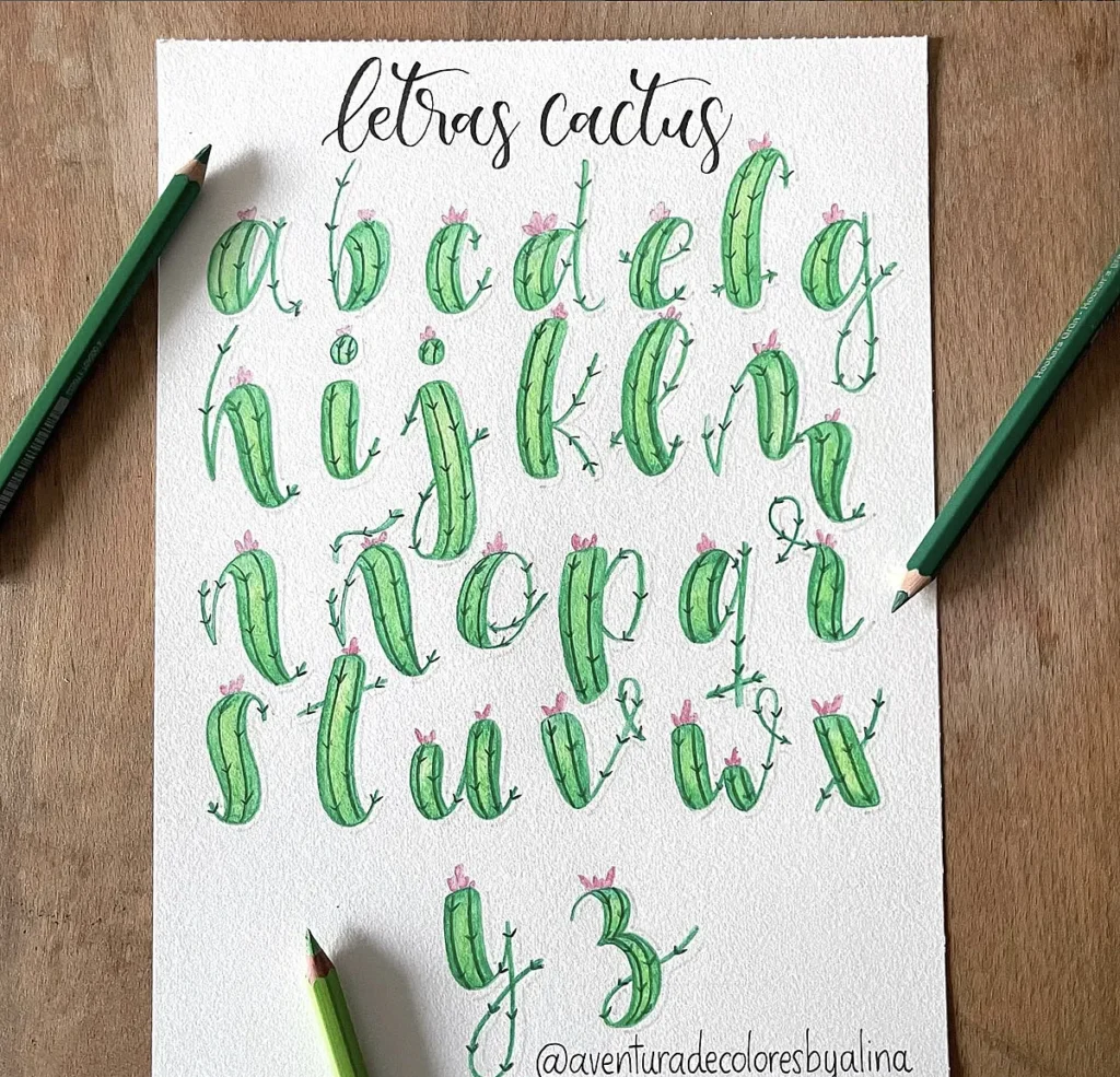 Alphabet letters styled like cacti with floral accents, surrounded by green colored pencils. Letras cactus at the top.