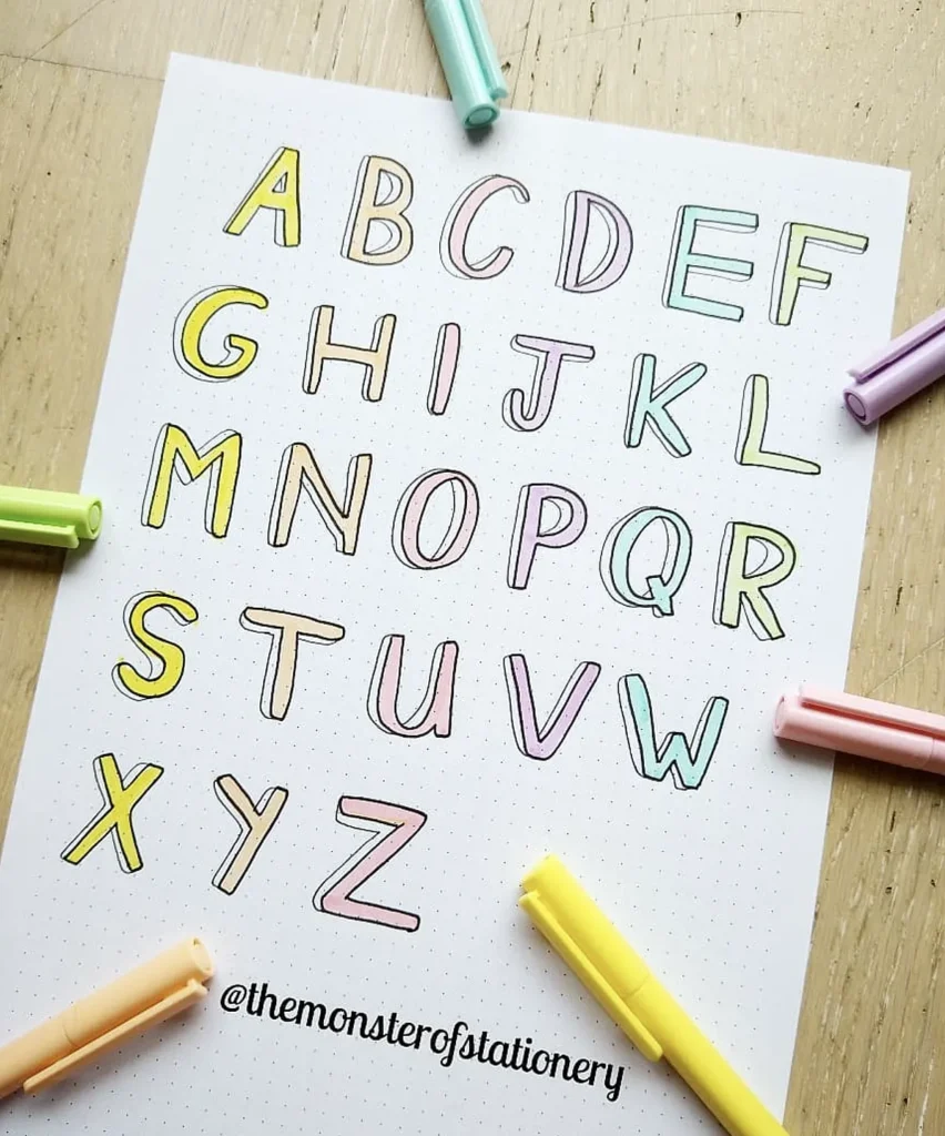 Colorful alphabet letters on a dotted paper surrounded by pastel highlighters, showcasing creative stationery design.