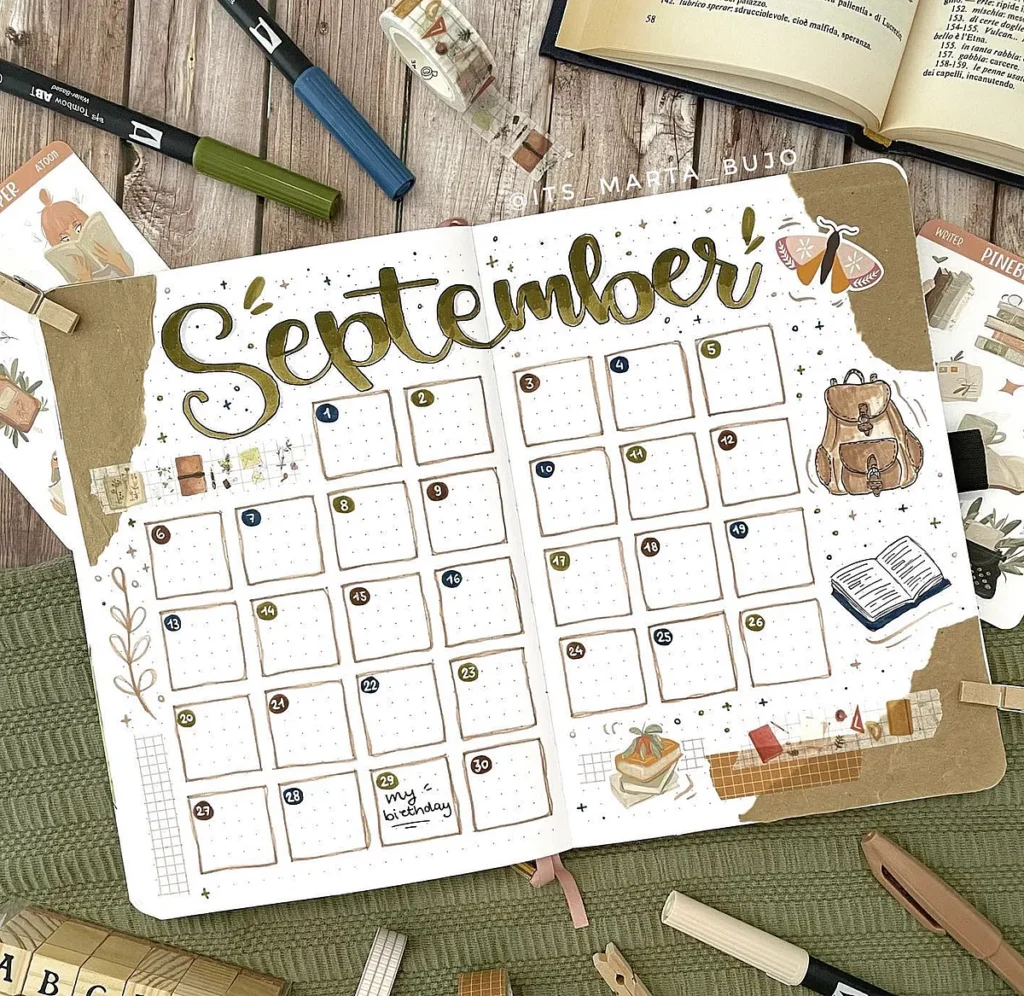 September bullet journal spread with calendar, doodles, and planner items on a wooden desk.
