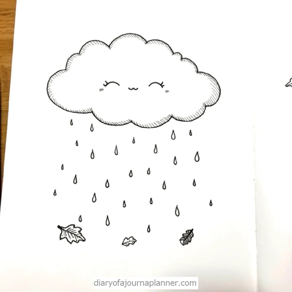 Cute smiling cloud with raindrops and autumn leaves doodle on a sketchbook page.