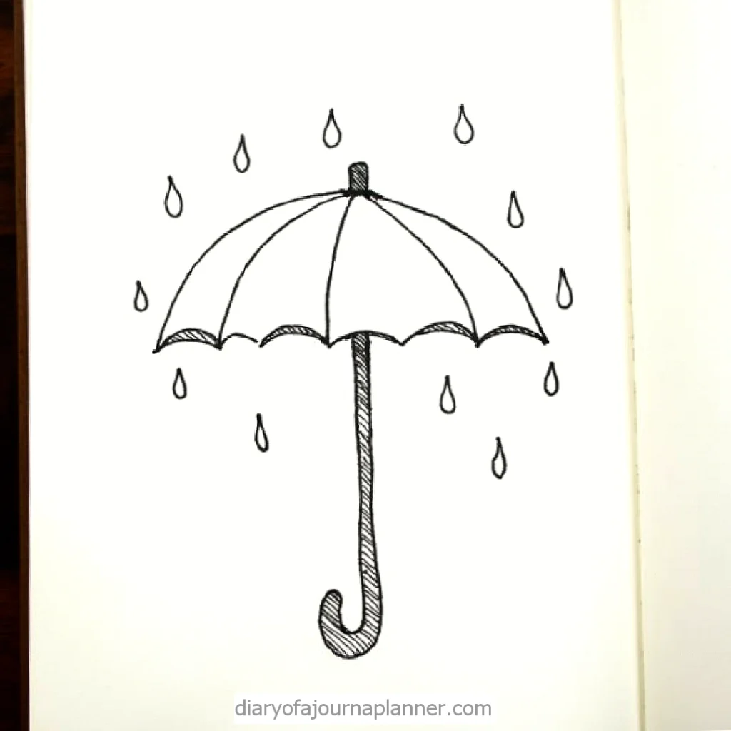 Black and white drawing of an open umbrella with raindrops. Simple doodle on a notebook page.