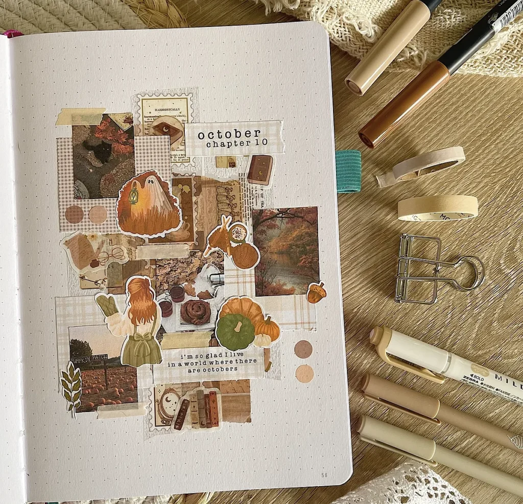 Scrapbook journal page with autumn-themed stickers and art supplies on a wooden table, celebrating October.