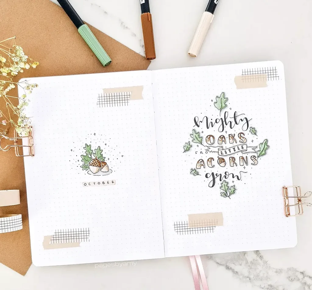 Bullet journal with October theme, featuring acorns and the phrase Mighty oaks from little acorns grow.