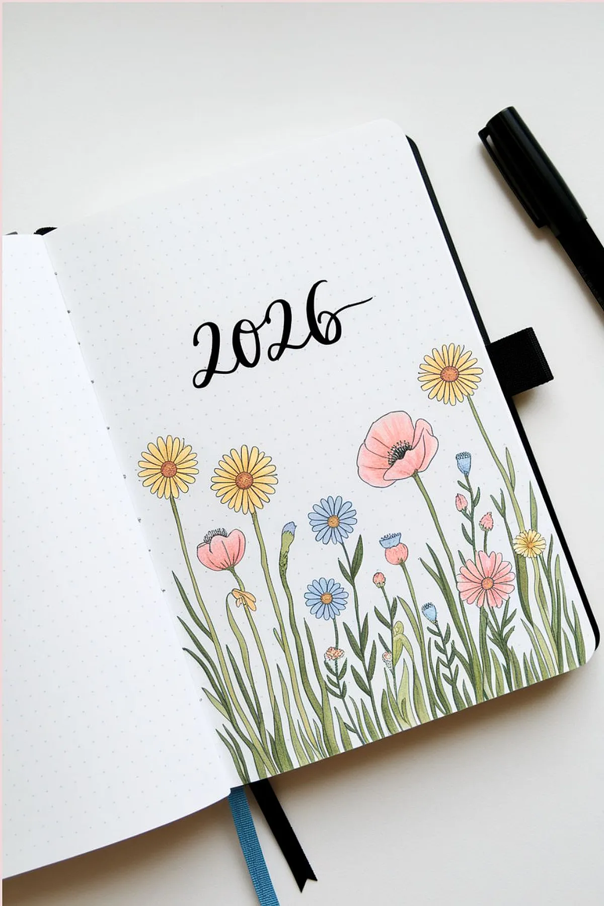 Bullet journal open to 2026, featuring colorful floral illustrations and elegant script writing with 2026 bullet journal ideas