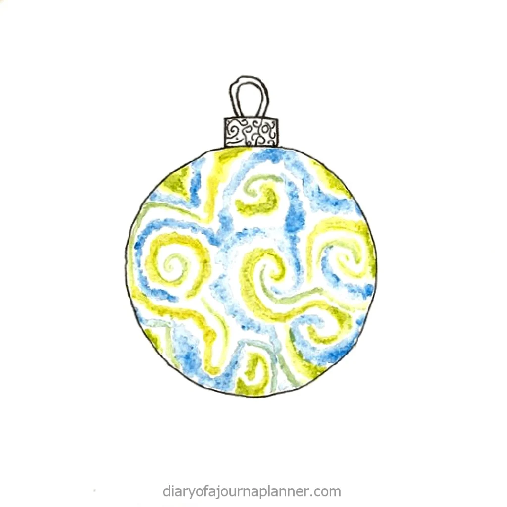 Colorful Christmas ornament with swirling blue and green design on a white background.