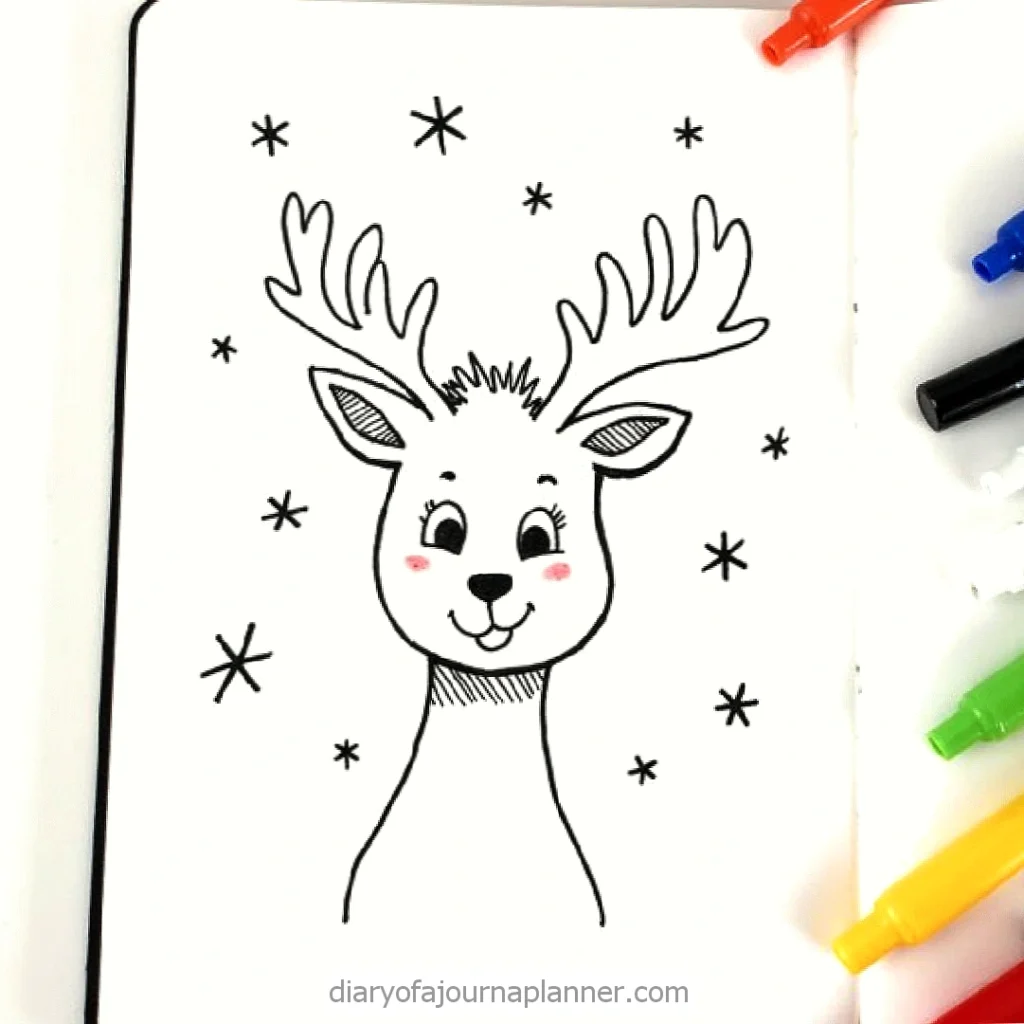 Cute reindeer drawing with snowflakes, surrounded by colorful markers. Perfect for holiday journal or planner.