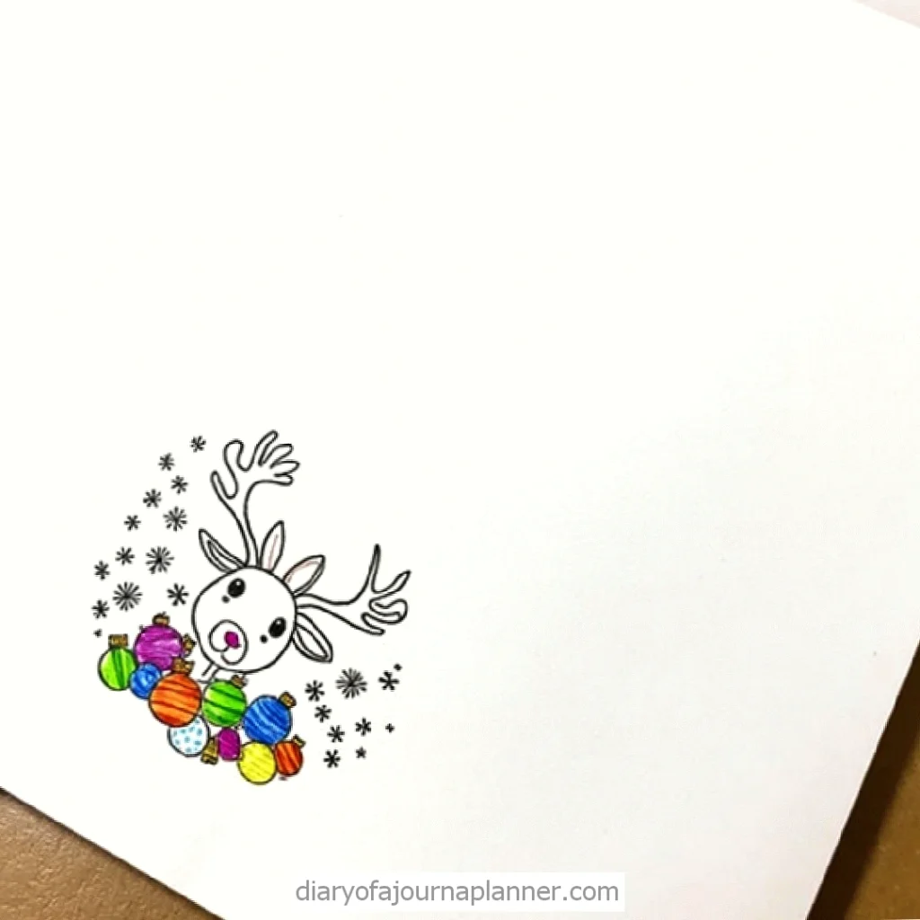 Cute reindeer illustration with colorful Christmas ornaments and snowflakes on a journal page.