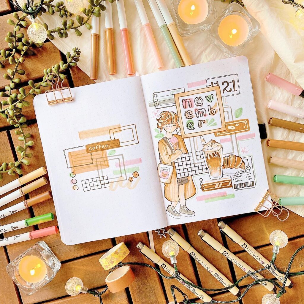 November bullet journal layout with fall-themed doodles, coffee, and colorful pens on a wooden table.