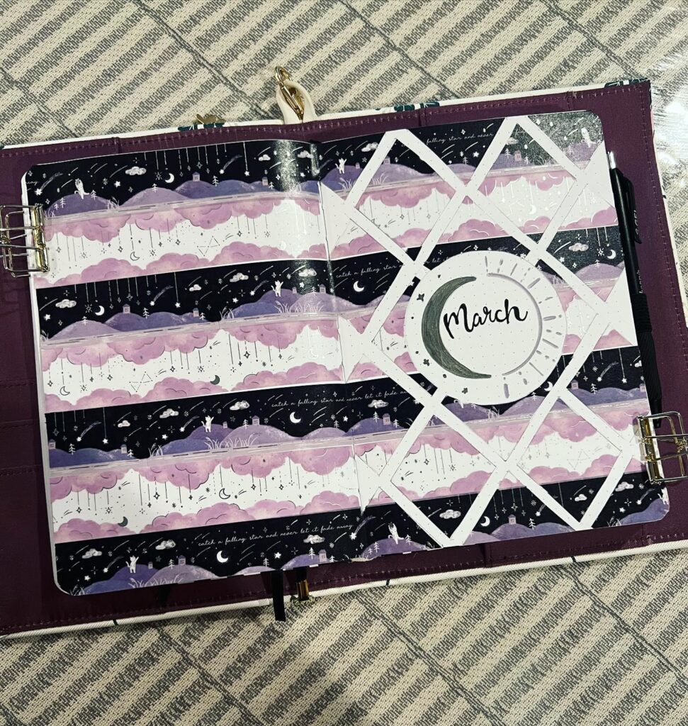 March bullet journal page with purple cloud and night sky design on a checkered background.