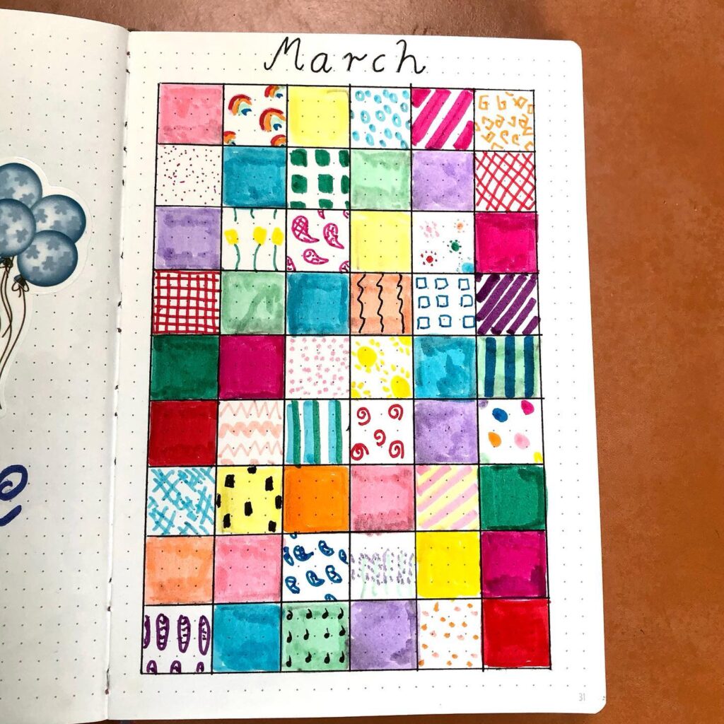 Colorful March bullet journal page with a grid of vibrant, patterned squares for daily entries.