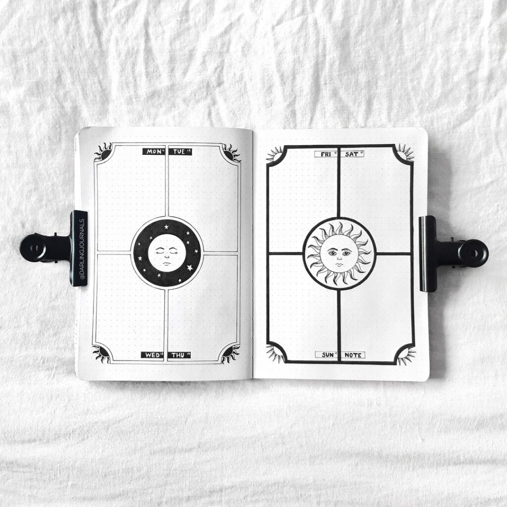 Open journal with celestial sun and moon drawings, days labeled from Monday to Sunday. Black and white aesthetic.