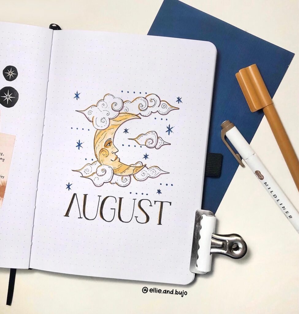 Bullet journal page for August, featuring a celestial moon and clouds design with pens and paper accessories.