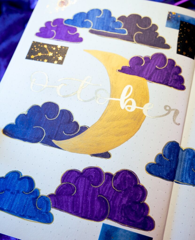 Decorative journal page for October with colorful clouds and crescent moon design.