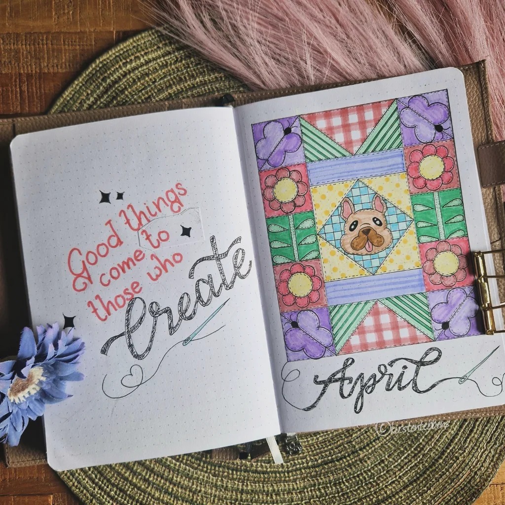 Bullet journal with Good things come to those who create and colorful April design with flowers and a dog's face.