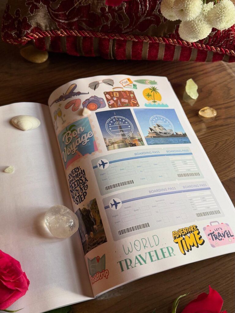 Open travel scrapbook with stickers, boarding passes, and travel-themed decorations on a wooden table.