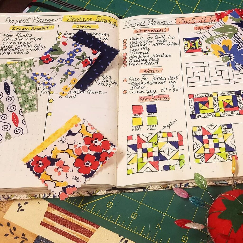 Open project planner for quilting with colorful fabric swatches and quilt pattern sketches on a creative workspace.