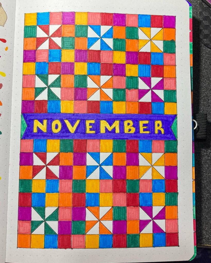 Colorful geometric pattern with November text in the center, featuring squares and triangles.