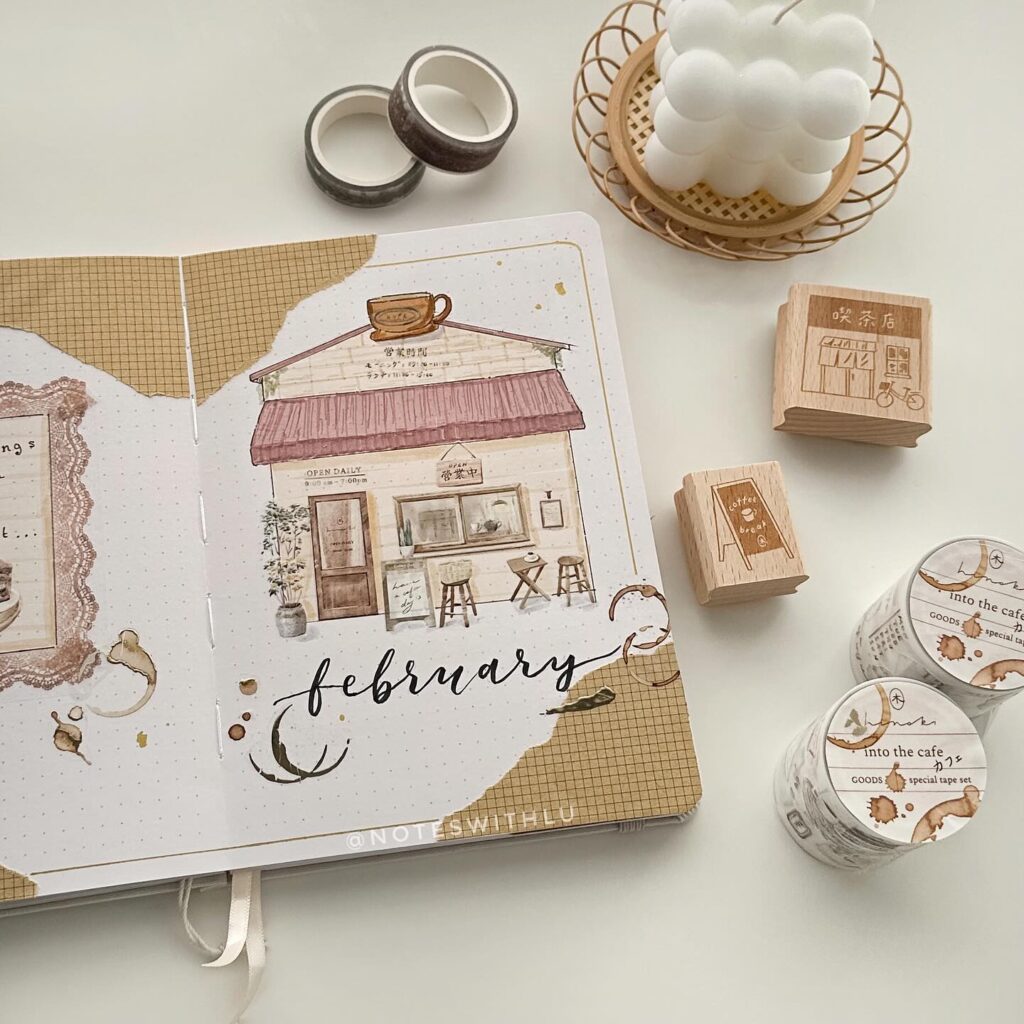 Creative bullet journal February spread with cafe theme, surrounded by decorative washi tapes and stamps.