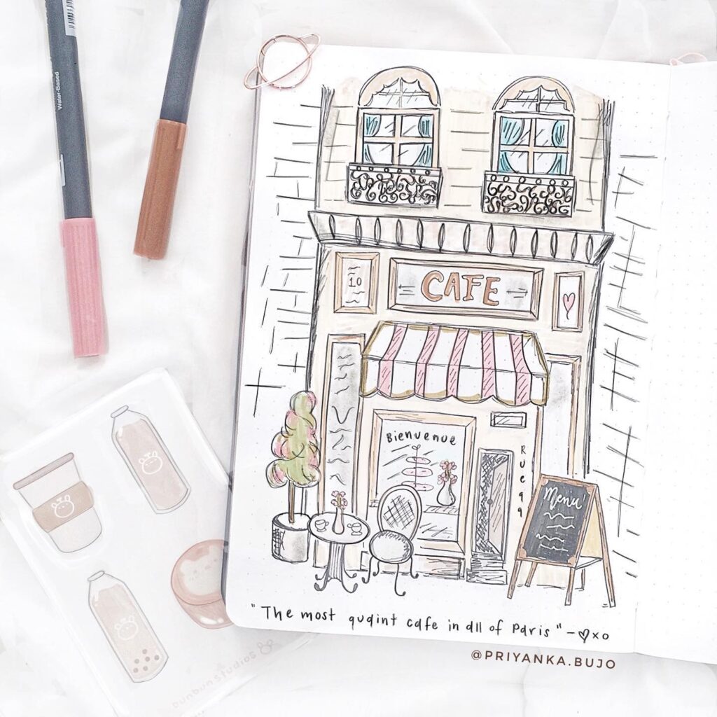 Illustration of a charming Parisian café with awnings, tables, and artistic details. Sketch by Priyanka.bujo.