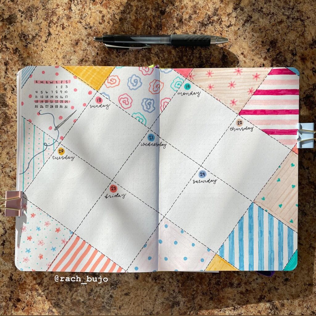 Creative bullet journal weekly spread with colorful patterns and a pen on a marble surface.