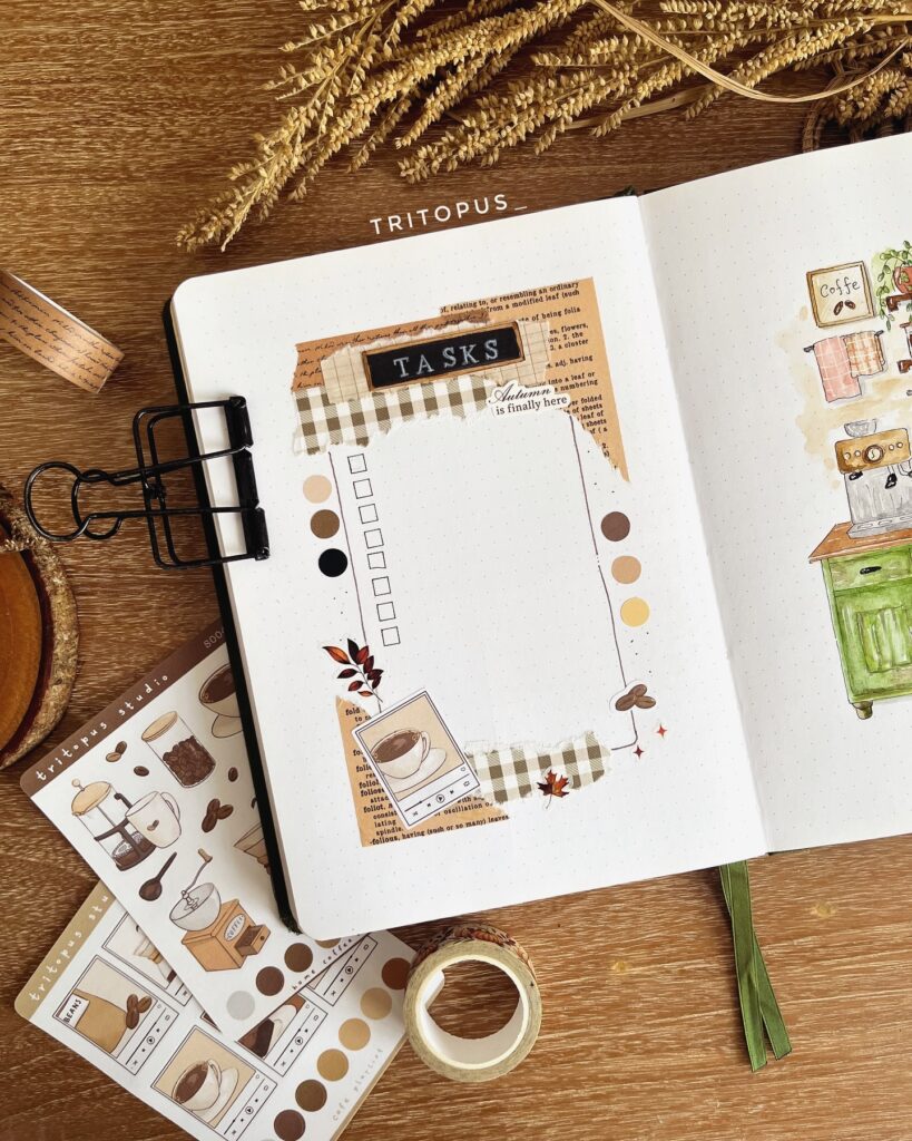 Bullet journal autumn theme with task list and coffee art stickers on wooden desk.