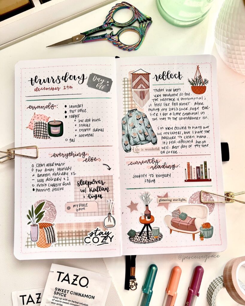 Decorative bullet journal spread with scissors, Tazo tea, and colorful pens on a desk.