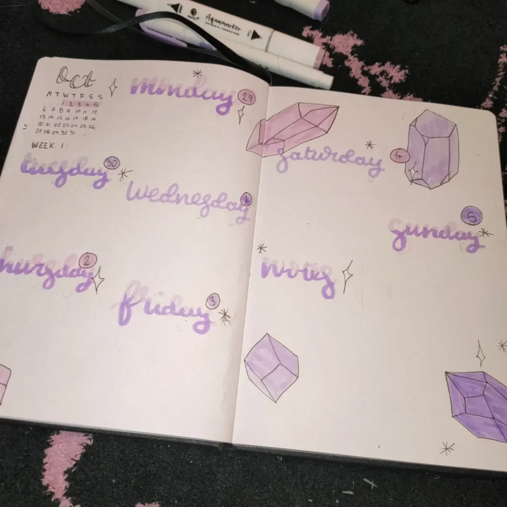 Bullet journal October weekly spread with purple calligraphy and crystal drawings.