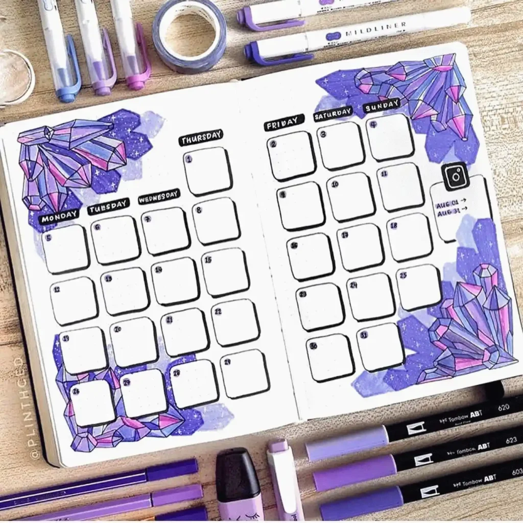 Decorative bullet journal spread with crystal designs and pens for August planner setup.